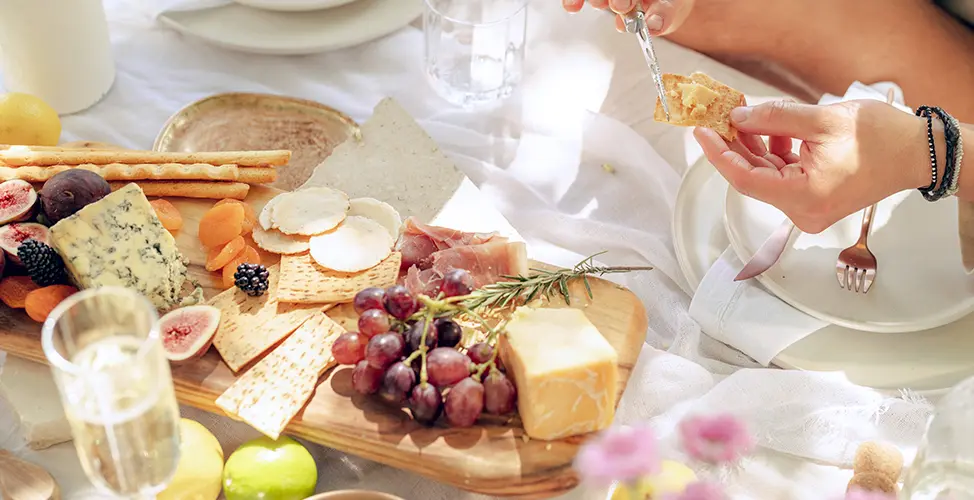 image of a snack board with grapes, cheese and crackers